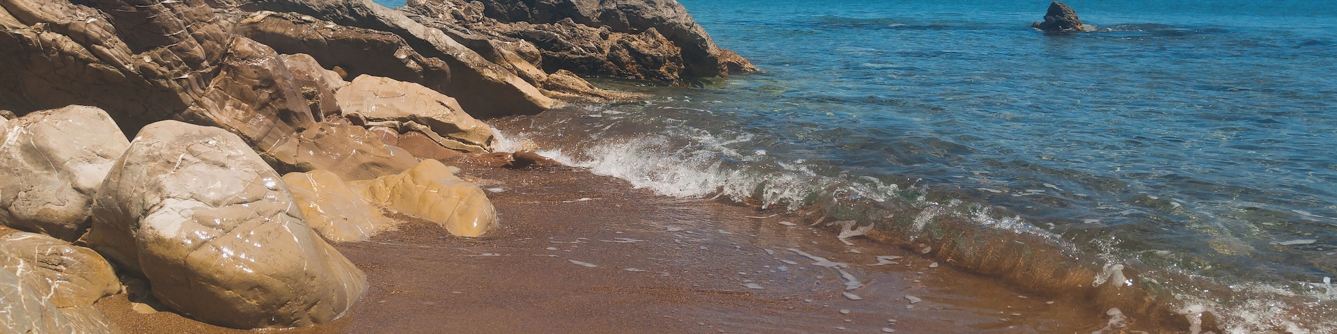 Hit the road to Koroni in Messinia, Greece. Almost near the town road get just near the beach with orange sand and blue crystal water. Perfect period to visit - end of May. Fresh but not cold water and super quiet!