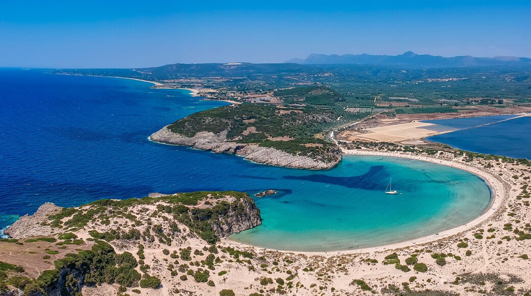 Aerial panorama view of the famous semicircular sandy beach and lagoon of Voidokilia in Messenia, Greece