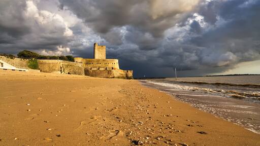 Fort Vauban de Fouras as seen from the Grande Plage beach during sunset with a storm coming in, Fouras, France