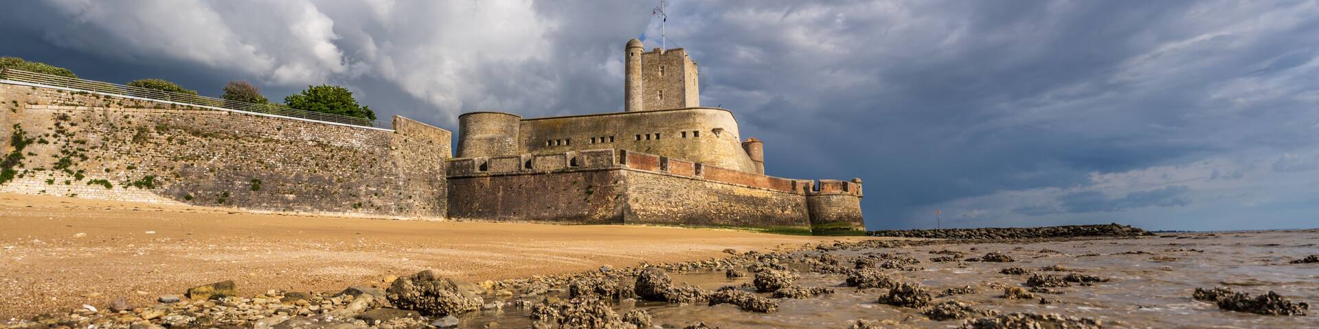 Fort Vauban de Fouras as seen from the Grande Plage beach during sunset with a storm coming in, Fouras, France