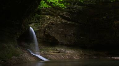 Sunlight shining on Cascade Falls on a Spring morning. Matthiessen State Park, Illinois, USA