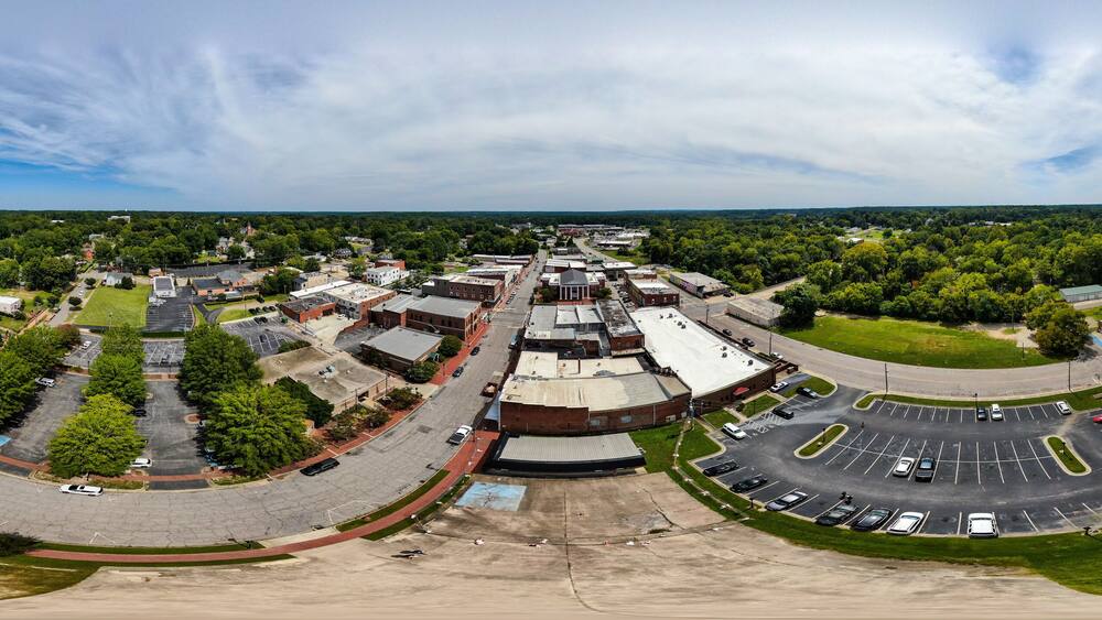 Daytime Drone Images of Downtown Louisburg North Carolina on a Sunny Day, Featuring the Historic Downtown Area, The Franklin County Courthouse, and The Tar River.