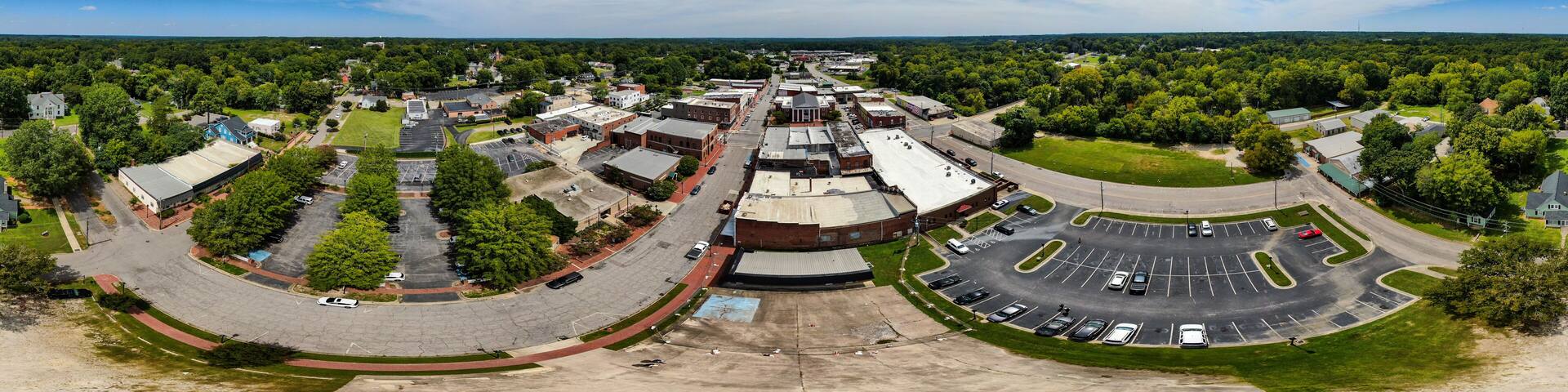 Daytime Drone Images of Downtown Louisburg North Carolina on a Sunny Day, Featuring the Historic Downtown Area, The Franklin County Courthouse, and The Tar River.