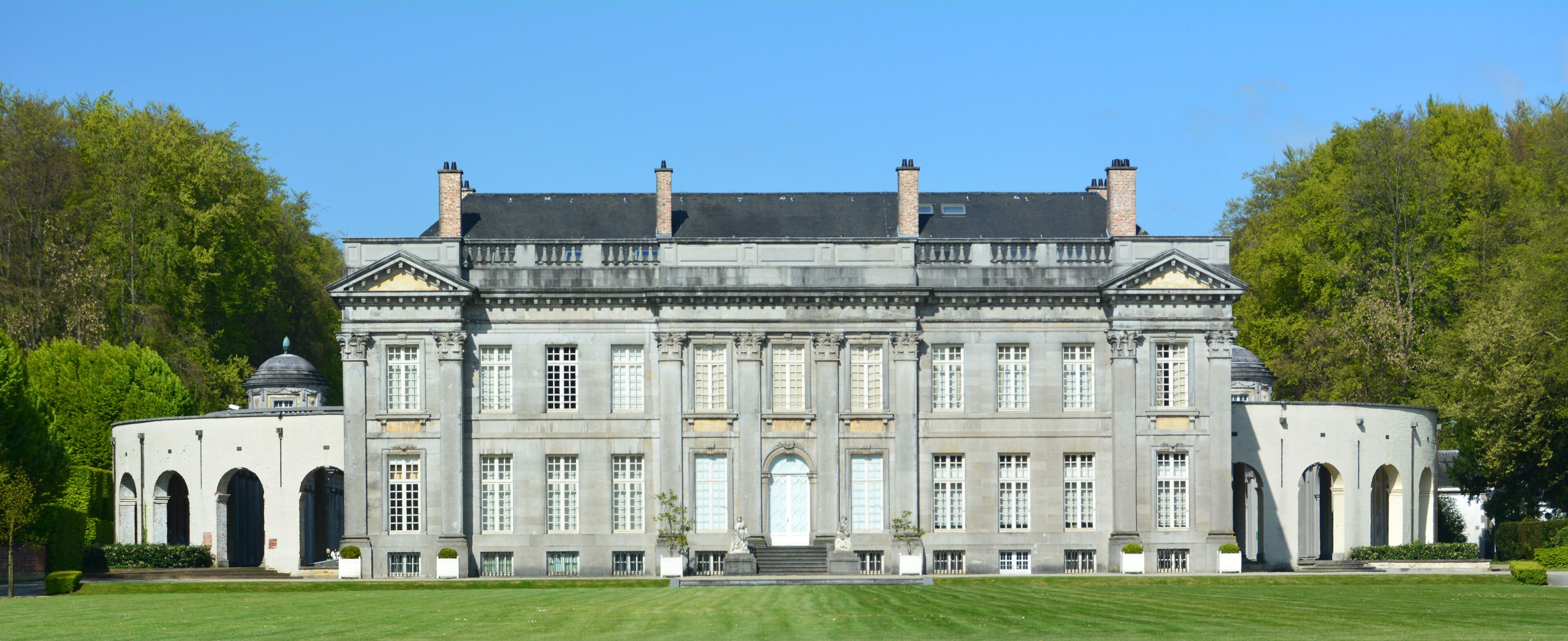A large, historic building with a symmetrical facade, large windows, and a central entrance.