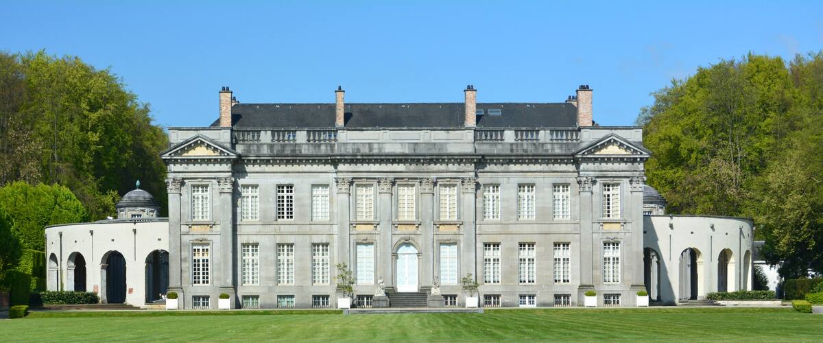 A large, historic building with a symmetrical facade, large windows, and a central entrance.