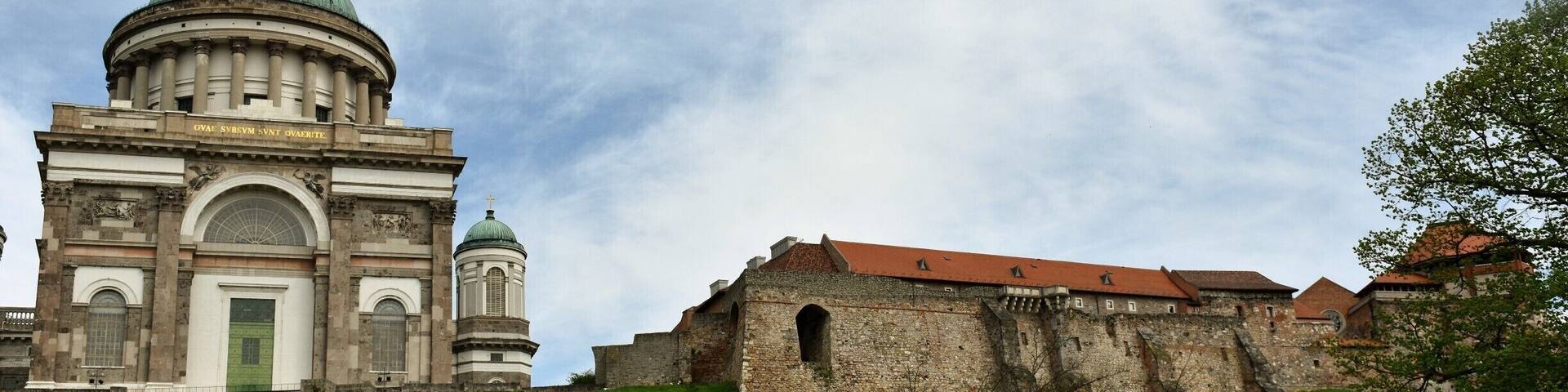 The Primatial Basilica of the Blessed Virgin Mary Assumed Into Heaven and St Adalbert also known as the Esztergom Basilica, is an ecclesiastic basilica in Esztergom, Hungary, the mother church of the Archdiocese of Esztergom-Budapest, and the seat of the Catholic Church in Hungary. It is dedicated to the Saint Mary of the Assumption and Saint Adalbert.
It is the largest church, and the tallest building, in Hungary. Its inner area is 5,600 m². It is 118 m long and 49 m wide. It has a reverberation time of more than 9 seconds. Its dome, forming a semi-sphere, is situated in the middle, and it has 12 windows. It is 71.5 m high inside, with a diameter of 33.5 metres, and is 100 m high from outside, counted from the crypt.
The altarpiece (13.5 × 6.6 metres, depicting the Assumption of the Blessed Virgin Mary, by Girolamo Michelangelo Grigoletti) is the largest painting in the world painted on a single piece of canvas.
The basilica is also known for Bakócz Chapel (named after Tamás Bakócz), built by Italian masters between 1506–1507 out of red marble of Süttő, its walls adorned with Tuscan Renaissance motifs. It is the most precious remaining example of Renaissance art in Hungary.
The huge crypt, built in Old Egyptian style in 1831, is today the resting place of late archbishops, among others, József Mindszenty, famous for his opposition to both Nazi and Communist rule