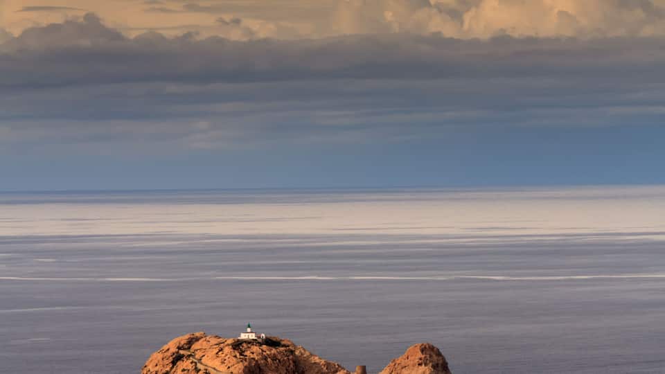 The red rock and lighthouse at Ile Rousse in the Balagne region of Corsica