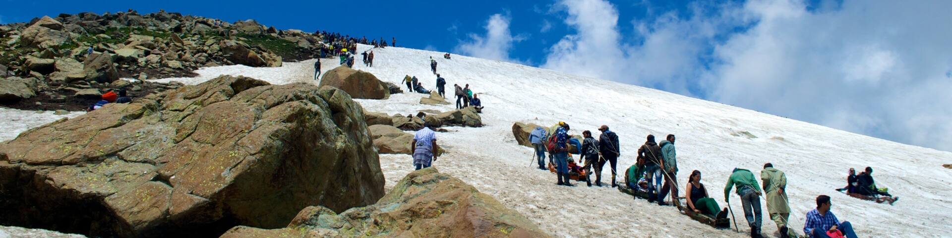 Gulmarg which includes mountains, snow tubing and snow