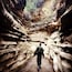 A person walking through a narrow canyon with layered rock formations.