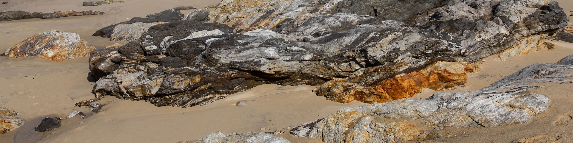 A rocky beach with waves crashing onto the shore.