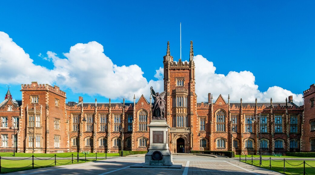 The Queen's University of Belfast with a grass lawn in sunset light. Wide panorama,