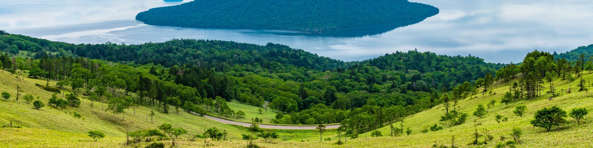Lake Kussharo in summer season sunny day. Natural landscape from Bihoro-toge pass lookout view point. Akan Mashu National Park, Hokkaido, Japan