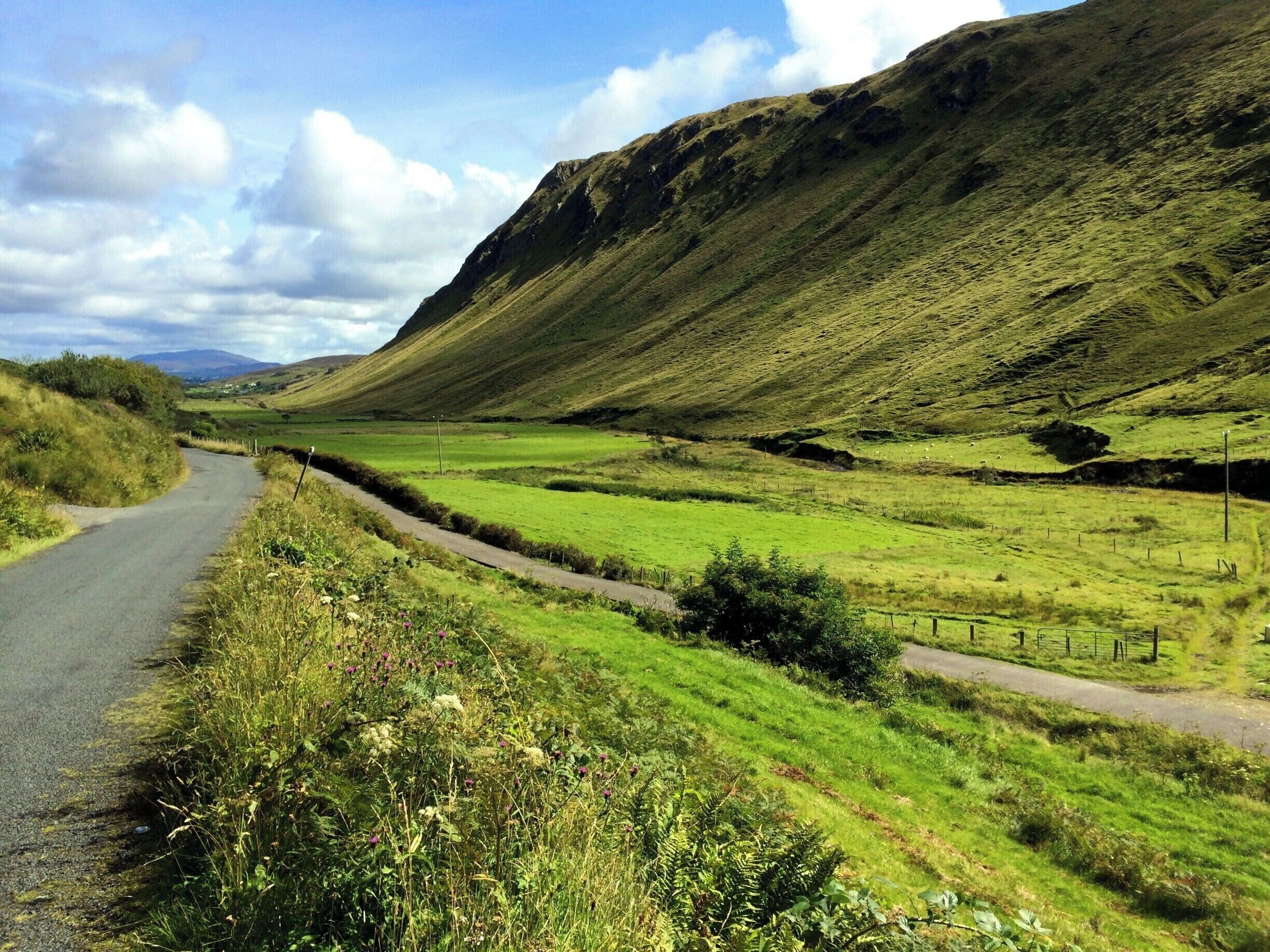 County Donegal boasts some remarkable landscape diversity. All of the county was glaciated up to about 10,000 years ago and the effect of glaciation is everywhere in evidence still. Here at Glengesh, this wide and rounded valley, a U-shaped valley, is the classic shape of a glaciated valley. A great county to explore if you are interested in geology or topography.
