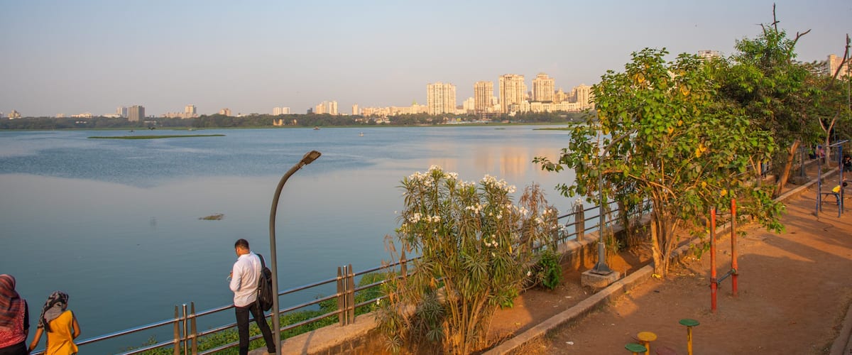 Powai Lake featuring a sunset and a bay or harbor