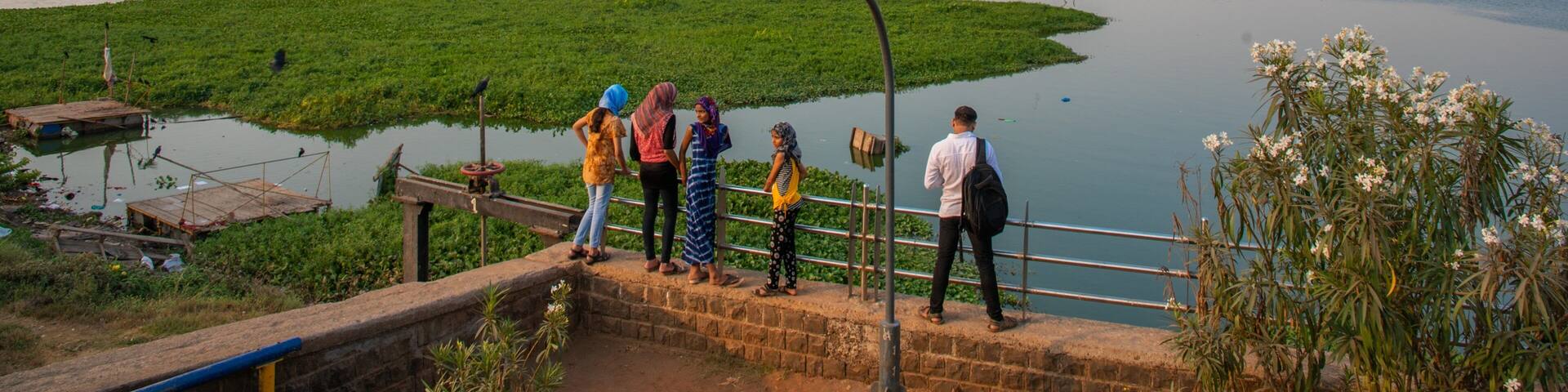 Powai Lake showing a river or creek and views as well as a small group of people