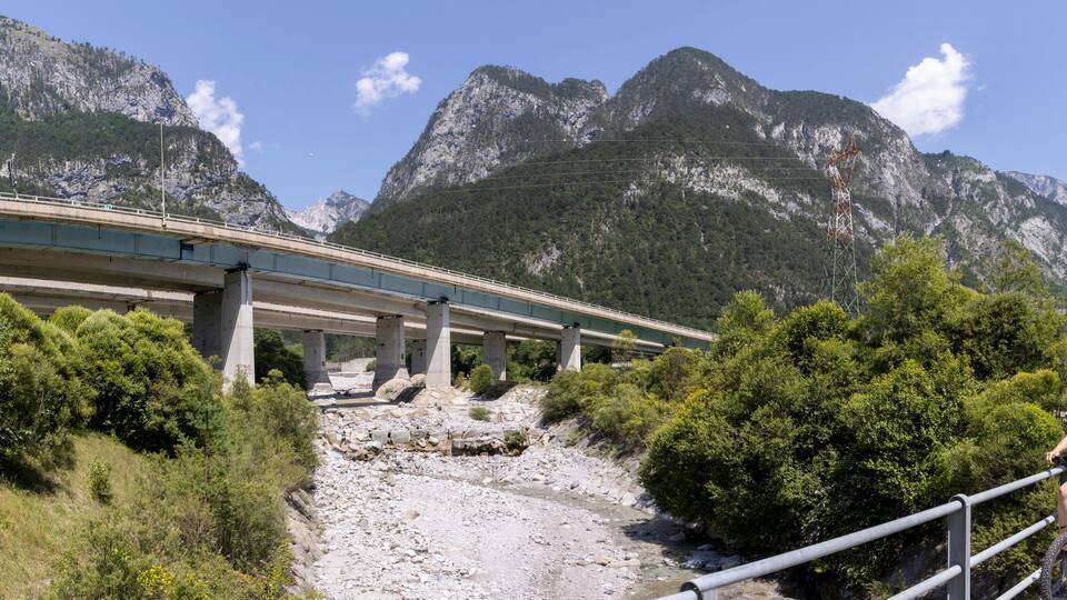 woman with e-bike on the alpe adria cycle route ( Pontebanna ) through the Val Canale in Italy