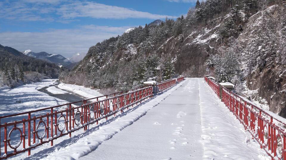 Panoramic view of the alpine village of Bagni di Lusnizza and the Fella River from the bridge of the Alpe Adria cycle route