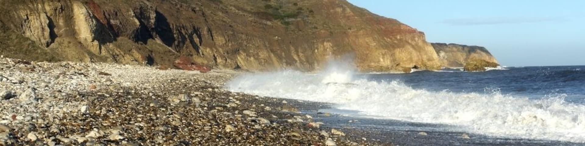 Beach east of Easington Colliery The large sea-battered rock can be seen off the near headland at Loom.