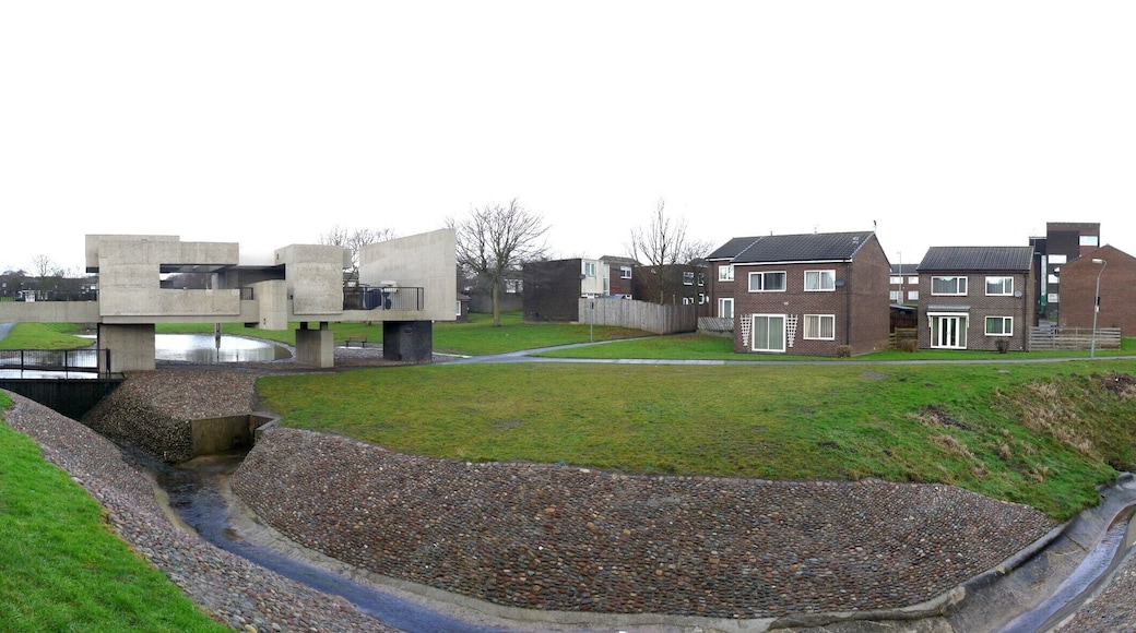 The heart of Peterlee Victor Pasmore's 'Apollo Pavilion' can be seen to the left, crossing the stream, amid a typical residential scene in Peterlee new town, which characteristically includes lots of open space around scattered houses and low level apartment blocks.