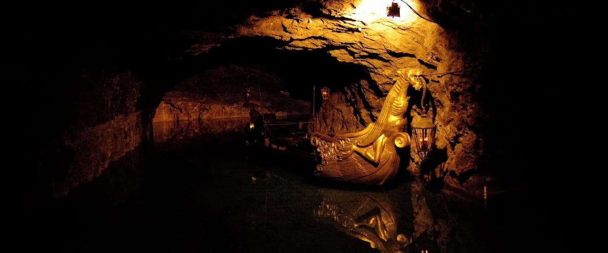 A cave with a golden statue and a lantern.