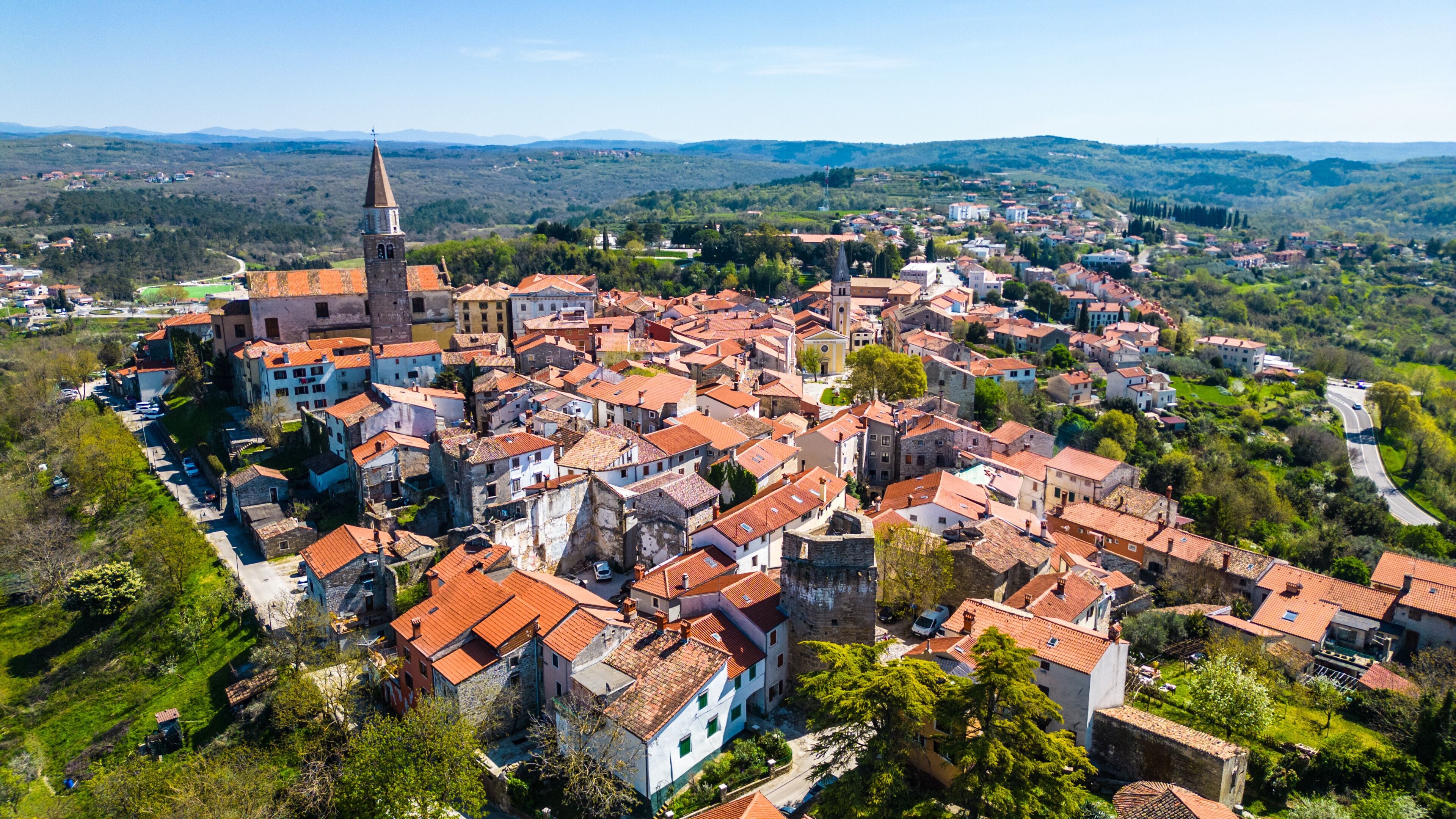 Aerial view of Buje, a charming medieval hilltop town in Istria, Croatia. Its historic architecture and lush surroundings make it a picturesque travel destination.