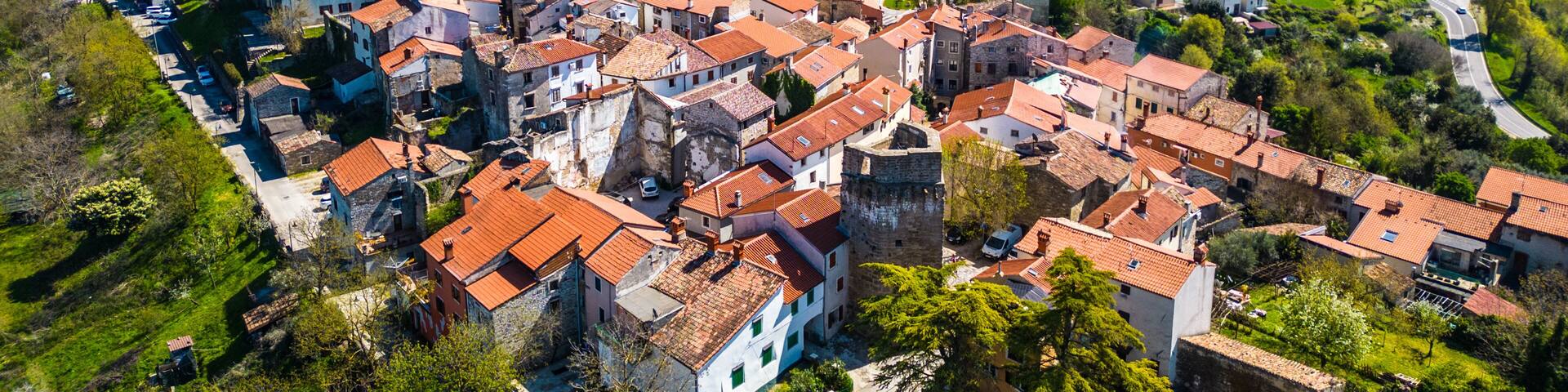Aerial view of Buje, a charming medieval hilltop town in Istria, Croatia. Its historic architecture and lush surroundings make it a picturesque travel destination.