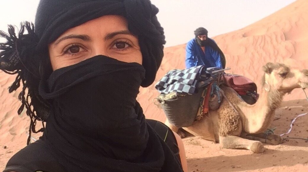 Taking a desert camel ride and camping overnight in the Sahara