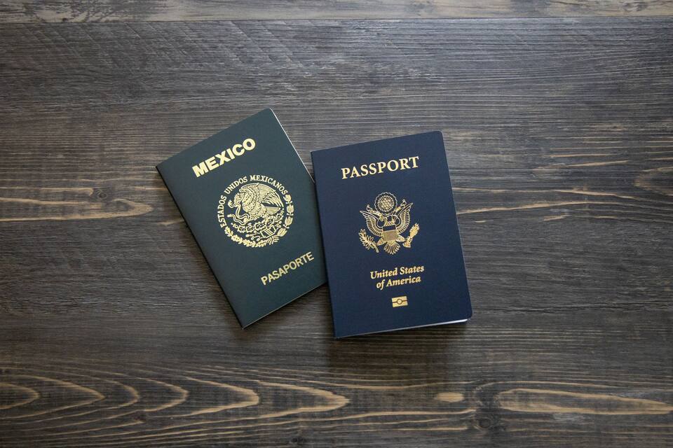 Two passports on a wooden surface.