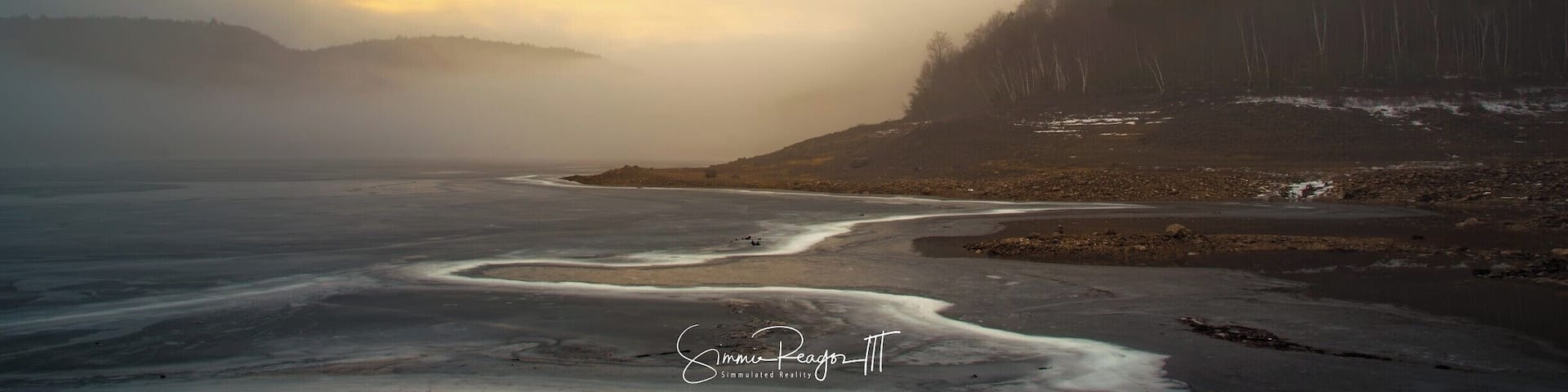 A foggy morning on the Colebrook River Lake. The sheer lines in the frozen reservoir look like the receding water on a shoreline.