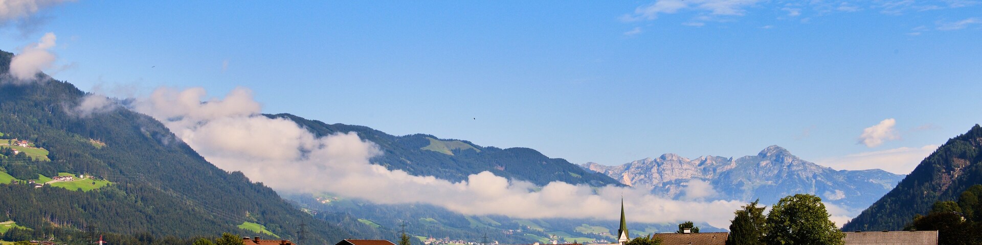 A mountainous landscape with houses and green fields.