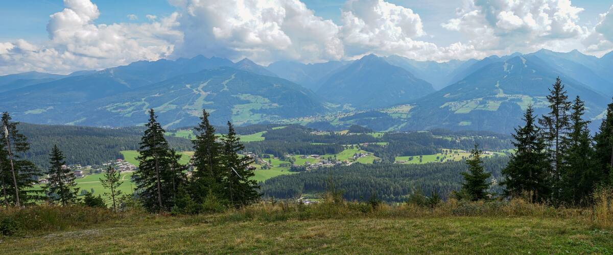 A mountainous landscape with a village nestled in the valley.