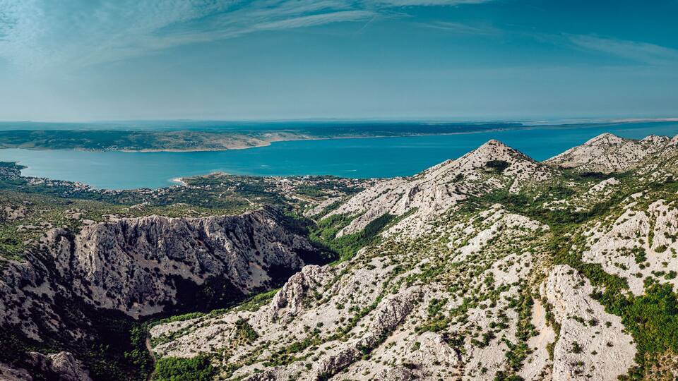 A mountainous landscape with a coastal view.