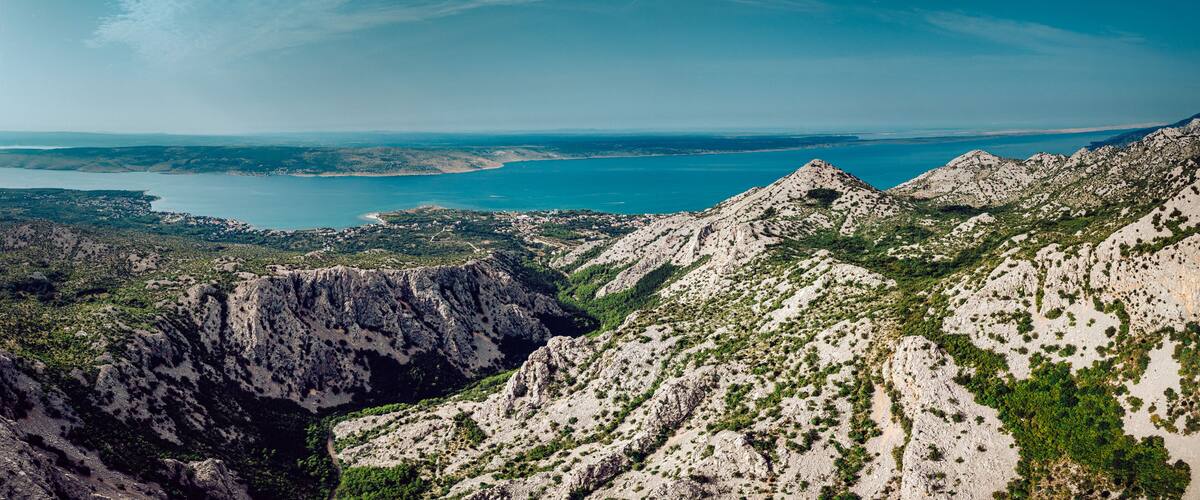 A mountainous landscape with a coastal view.