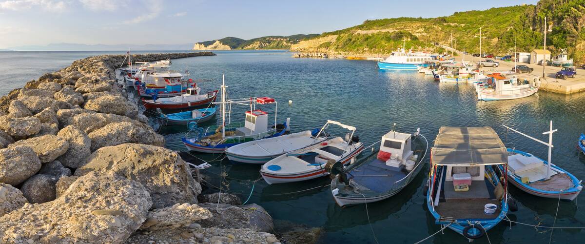 A harbor with boats docked along a rocky breakwater.