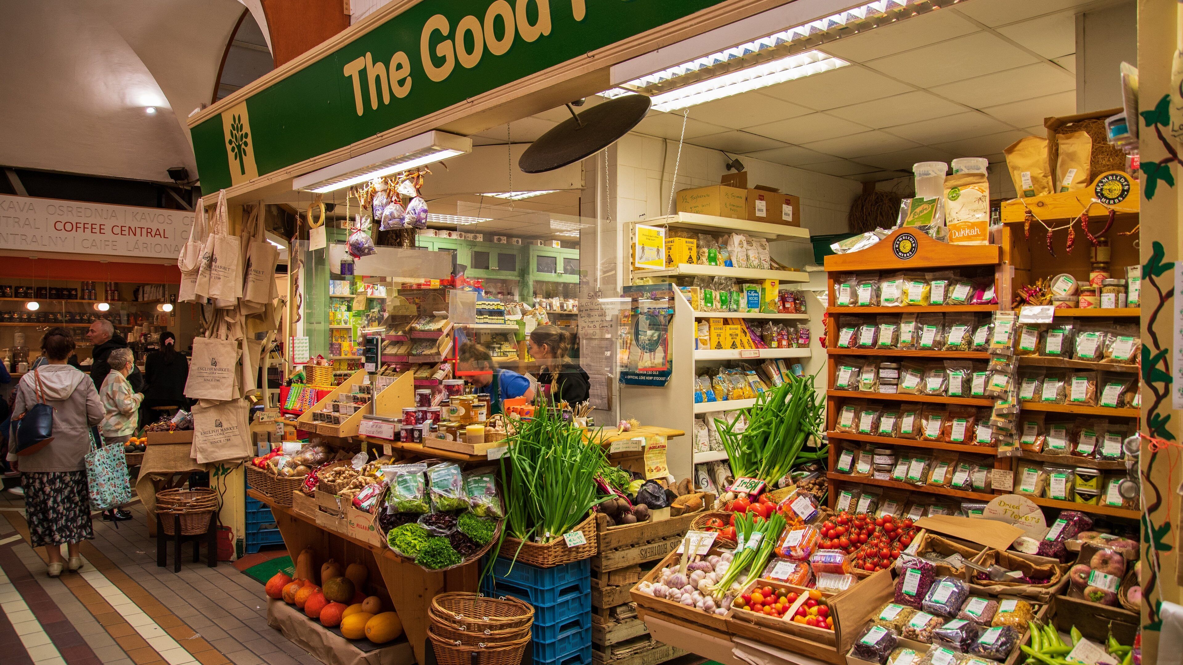 A bustling market with various stalls selling fresh produce, spices, and other goods.