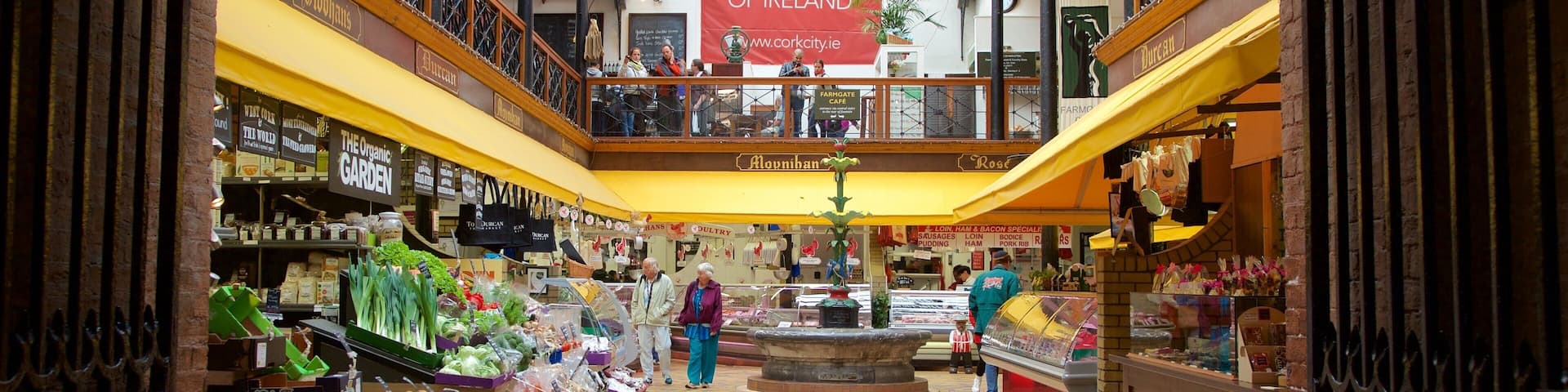 An indoor market with various stalls selling organic foods and fresh produce.