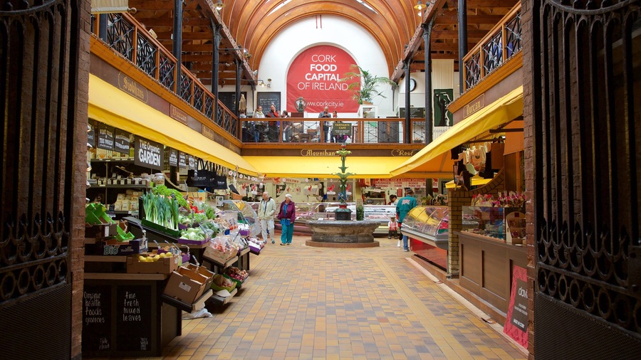 An indoor market with various stalls selling organic foods and fresh produce.