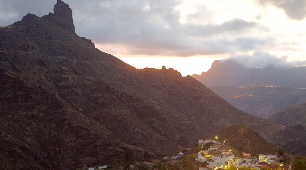 Tejeda which includes a sunset, a small town or village and mist or fog