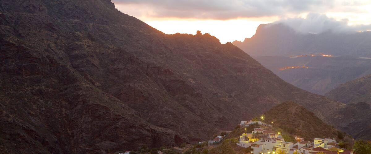 A mountainous landscape with a village at the base.