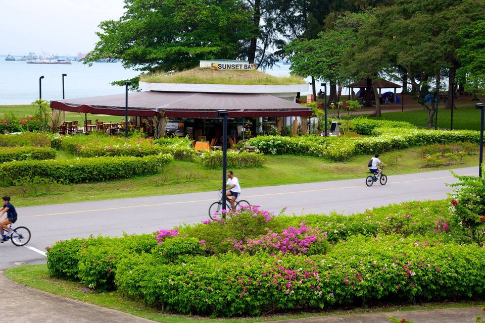 A park with a gazebo, a sign reading "Sunset Bay," and a waterfront view.