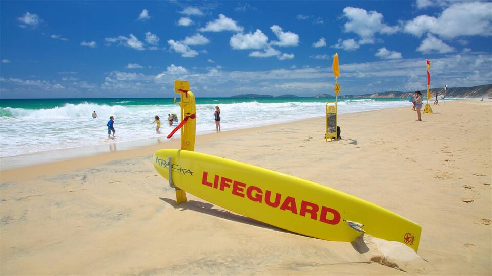 A lifeguard stand on a beach with the ocean in the background.