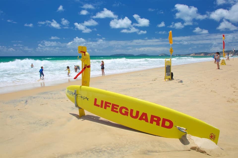 A lifeguard stand on a beach with the ocean in the background.