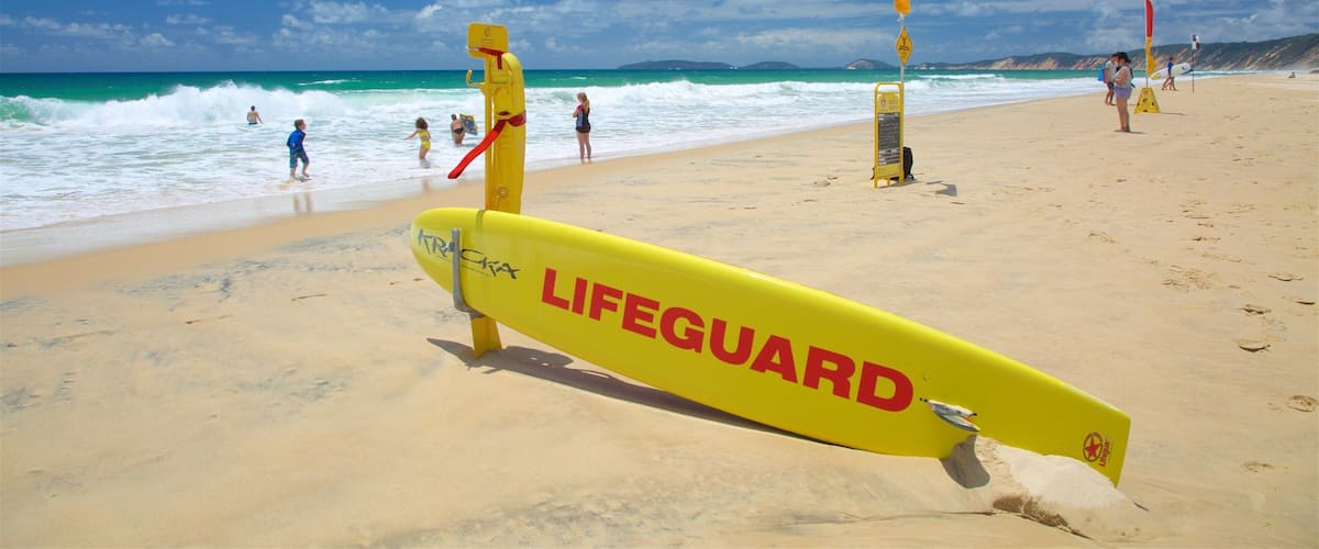 A lifeguard stand on a beach with the ocean in the background.