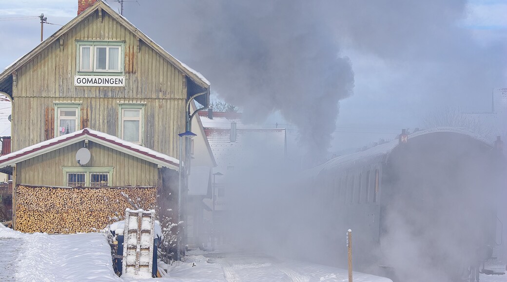 Snowy wintery railway station of Gomadingen with halting steam train, Gomadingen, Swabian Alb, Baden-Wurttemberg, Germany, November 28, 2010.