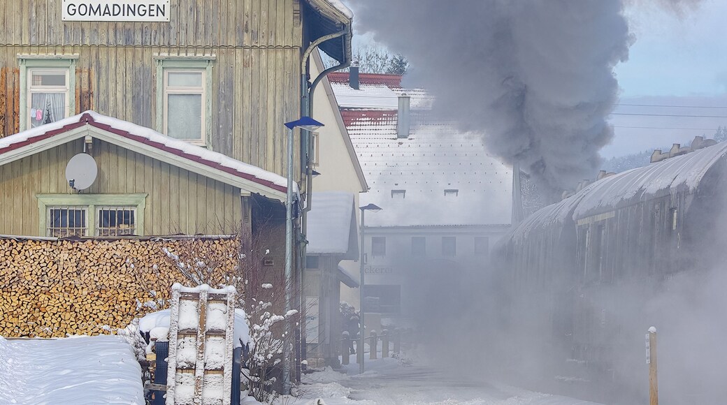 Snowy wintery railway station of Gomadingen with halting steam train, Gomadingen, Swabian Alb, Baden-Wurttemberg, Germany, November 28, 2010.