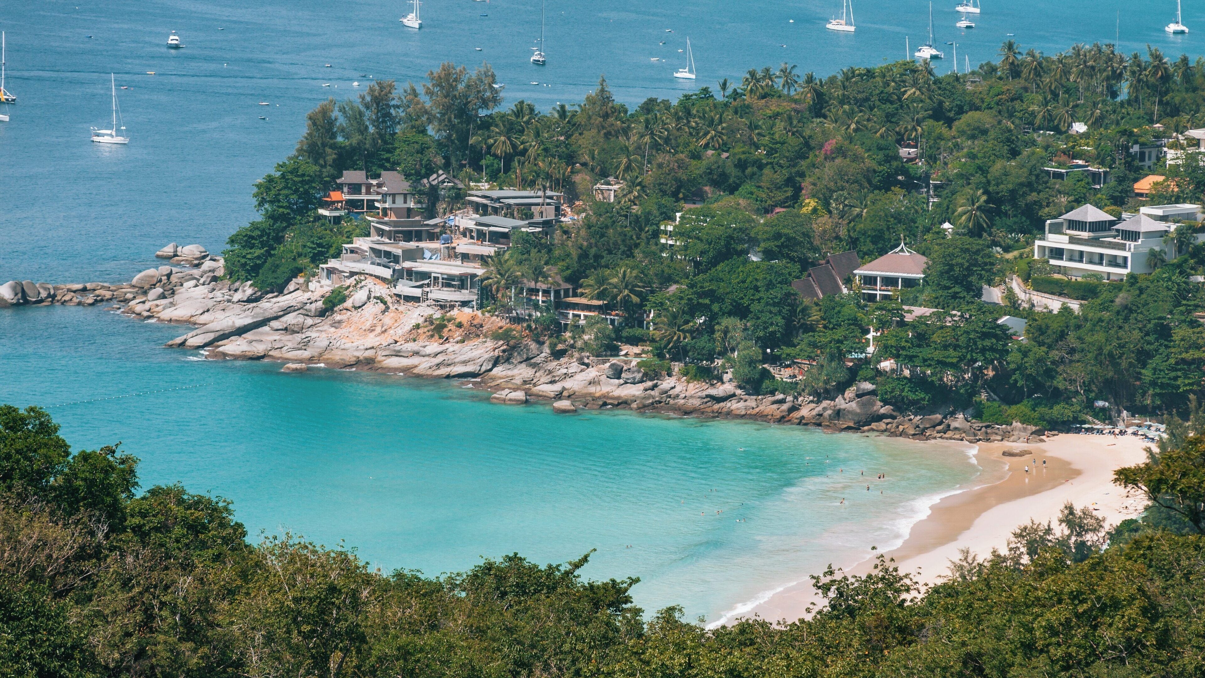 Beautiful Patong Beach reveals crystal clear waters and lush greenery in Kathu, Phuket Province, Thailand on a sunny day