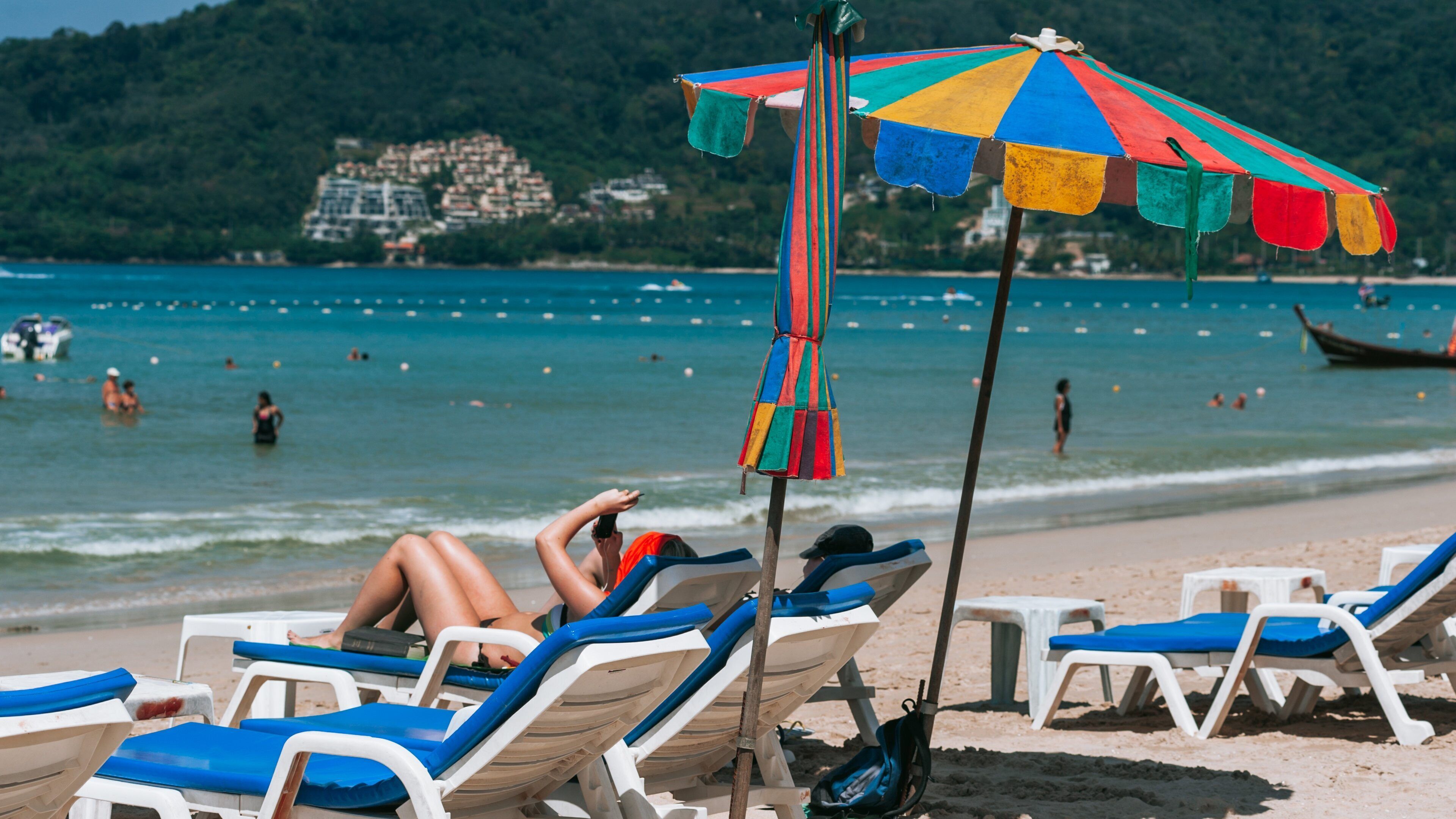 Patong Beach which includes general coastal views and a beach as well as a couple
