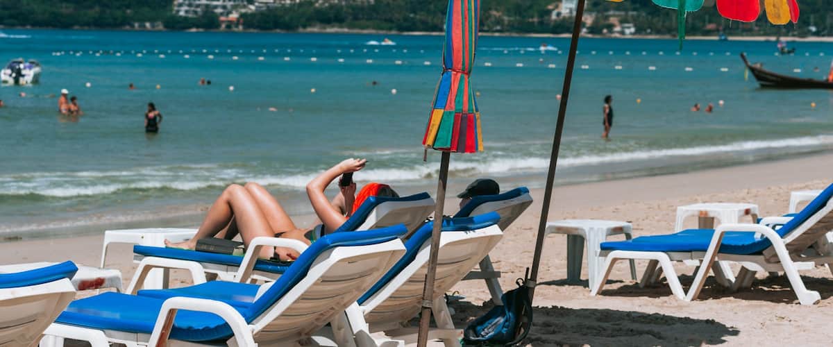 Patong Beach which includes general coastal views and a beach as well as a couple