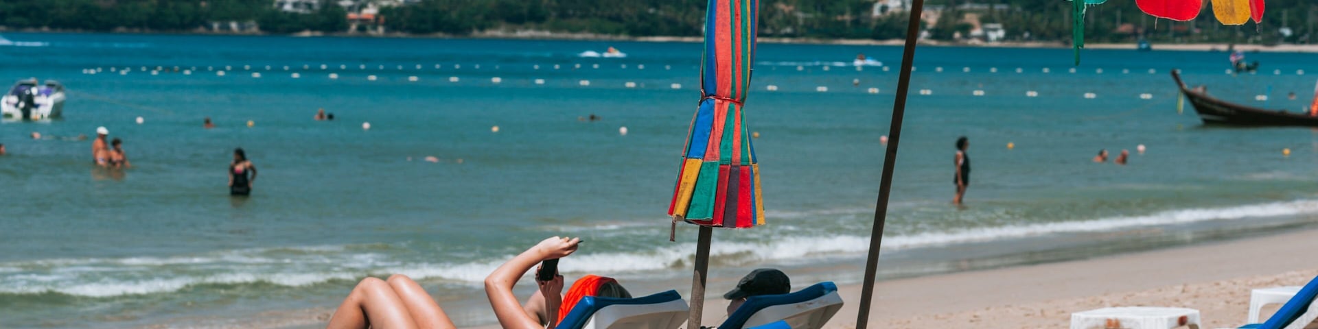 Patong Beach which includes general coastal views and a beach as well as a couple