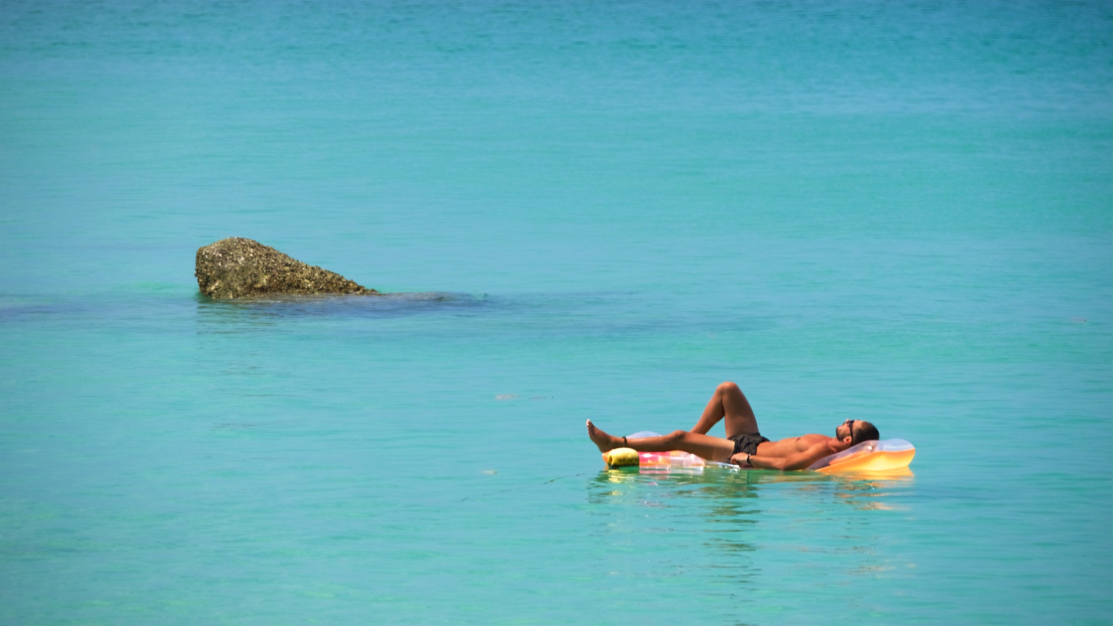 Surin showing a bay or harbor and swimming as well as an individual male